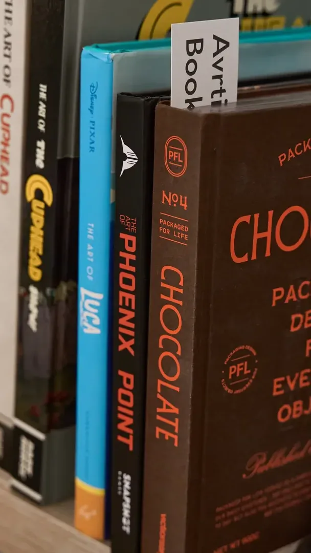 A shelf of design and packaging books in the Embrand studio
