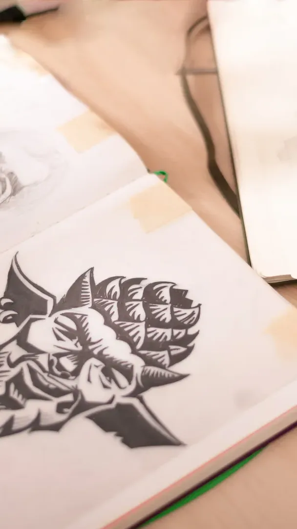 An illustration of a hop cone with a face in a sketchbook